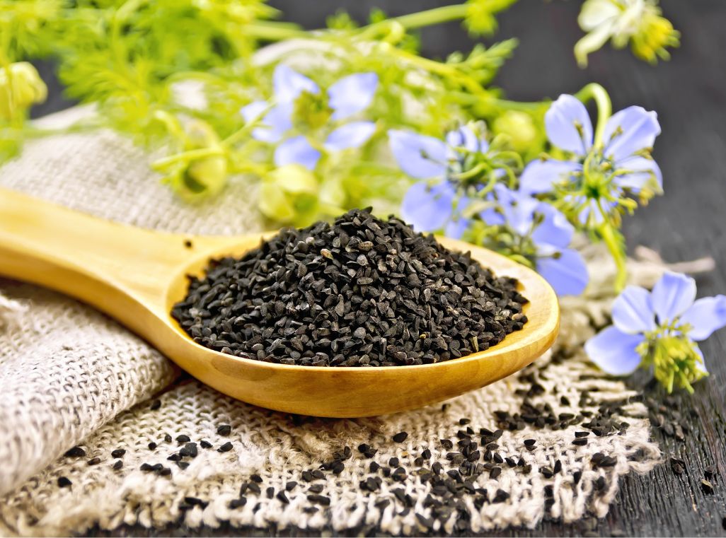 Zwarte zaad zaadjes op een houten lepel – Nigella sativa voor natuurlijke huidverzorging